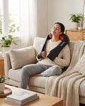 Person relaxing on a couch using the shiatsu neck and shoulder massager with heat