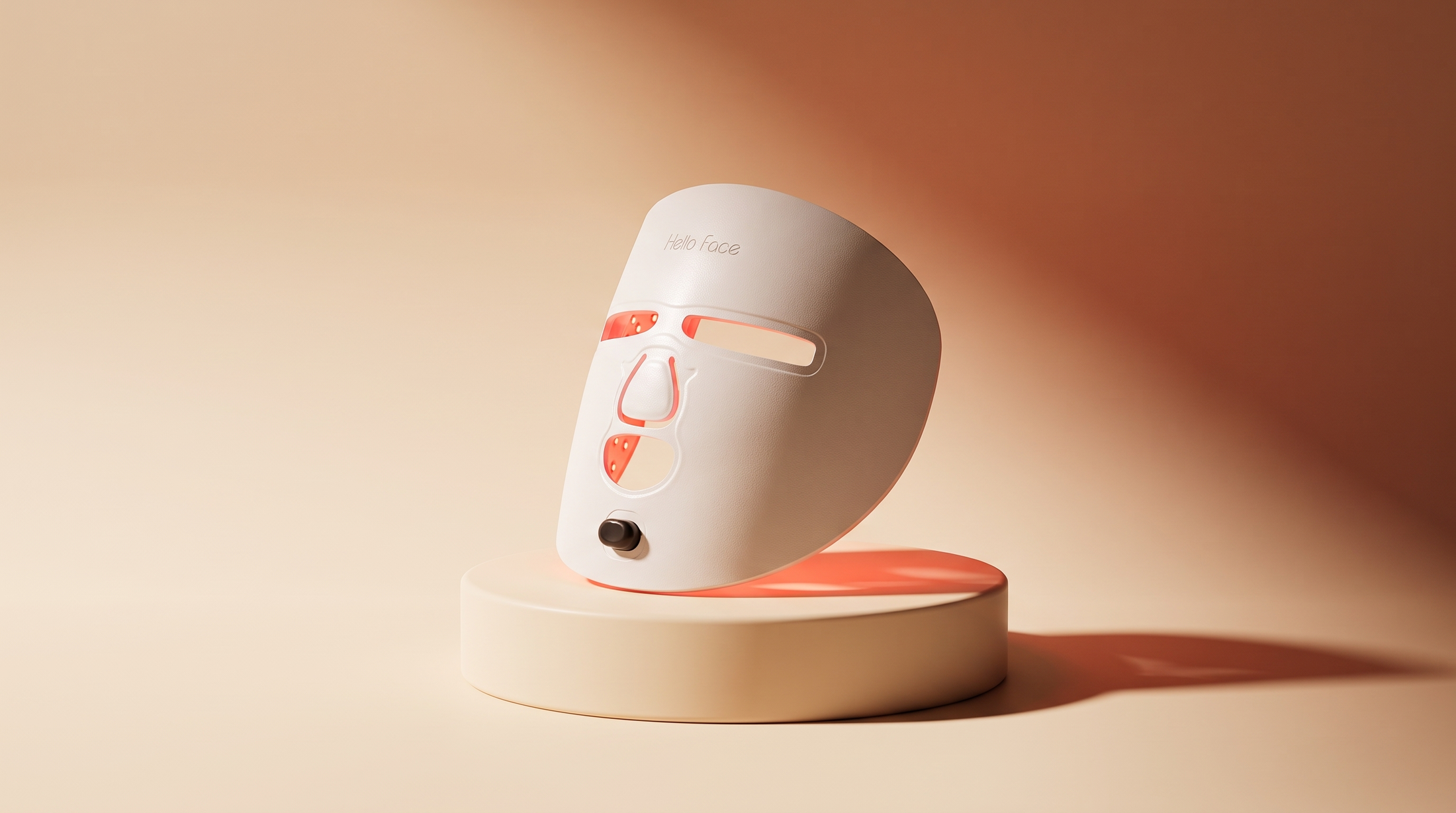 LED red light therapy mask displayed as a standalone hero product shot on a cream pedestal