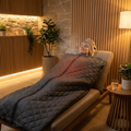 Person relaxing in an infrared sauna blanket at home
