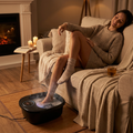 Person soaking feet in an electric foot spa bath